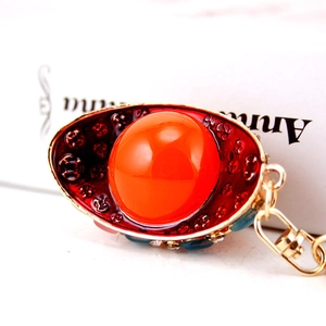 Chinese style gold keychain with orange gemstone and crystal inlaid yuanbao design
