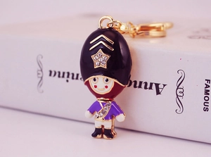 Close-up of a purple Royal Guard keychain with sparkling crystals and gold lobster clasp