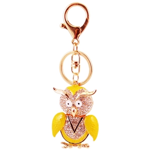 Sparkling gold owl keychain with crystal rhinestones and yellow enamel detail on white background