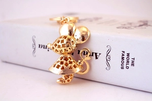 Close-up of golden rhinestone mouse keychain with clover cutout details and ring