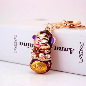 Golden monkey keychain with red enamel, faux pearl, and rhinestone 福 charm