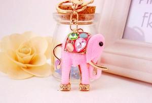 Close-up of pink resin elephant keychain with colorful rhinestones and gold-plated details