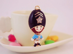 Detailed macro view of a royal guard keychain with crystals and enamel finish