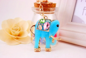 Detail of colorful resin elephant keychain with cat-eye stones and golden alloy hardware