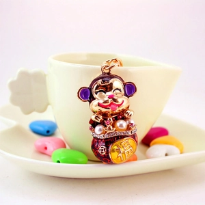 Cute cartoon zodiac monkey keychain with gold plating, purple enamel, and pearl charms