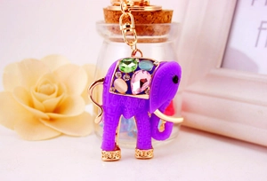 Detailed close-up of purple elephant keychain with colorful inlaid crystals and gold chain