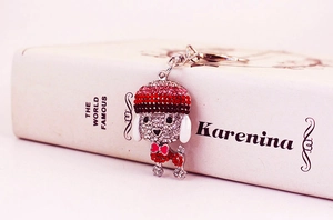Macro detail of a crystal-studded poodle keychain with colorful rhinestones and silver alloy
