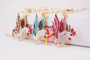 Close-up of rooster keychains with colorful crystals and gold-plated alloy clasps