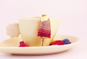 Detail of colorful ice cream keychain with gradient purple rhinestones and gold stick