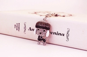 Macro detail of a crystal-encrusted poodle keychain with brown and black rhinestones