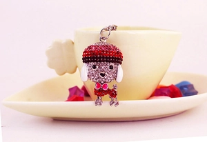 Detailed close-up of a rhinestone poodle keychain with pink bow and silver metal ring