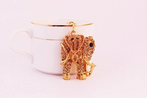 Detailed view of a golden elephant keychain with sparkling rhinestones and black gem eyes