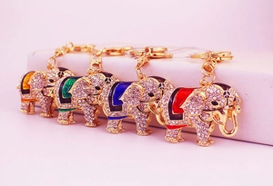 Detailed close-up of elephant keychains with colorful enamel saddles and crystal inlays