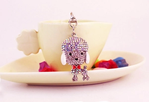 Close-up of sparkling crystal puppy keychain with red bowtie and silver lobster clasp