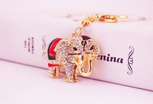 Detailed macro view of a gold-plated elephant keychain with rhinestones and enamel details