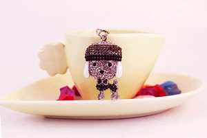 Detailed macro of sparkling poodle keychain with brown rhinestones and enamel ears