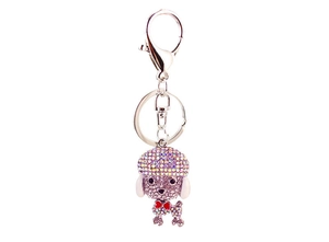 Macro detail of poodle keychain showing shimmering rhinestones and red bow accessory