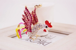 Detailed view of rooster keychain featuring sparkling crystals and vibrant enamel accents