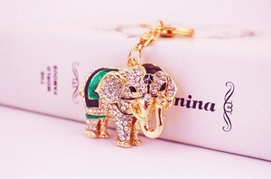 Detailed view of elephant keychain with sparkling rhinestones and green enamel on gold finish