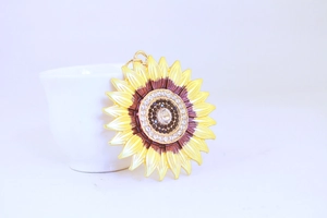 Detailed close-up of sunflower keychain featuring yellow petals and gemstone center