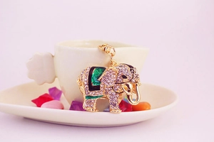Exquisite golden elephant keychain featuring sparkling rhinestones and green enamel details
