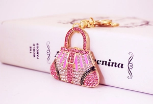 Detail of pink crystal handbag keychain with gold alloy frame and rhinestones