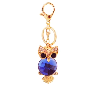 Porte-clés chouette doré avec cristal bleu taillé et détails en strass brillants