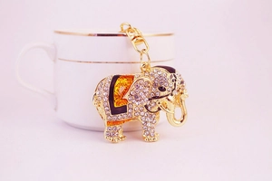 Detail of elephant keychain with sparkling rhinestones and colorful enamel on a cup