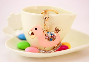 Close-up of pink crystal rocking horse keychain with gold alloy plating and colorful rhinestones