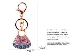 Macro view of crystal encrusted crossbody bag keychain with precise product dimensions