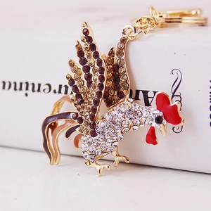 Creative rooster keychain in gold alloy with gradient rhinestones and red drip oil details