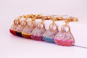 Close-up of 6 colorful crystal-encrusted mini handbag keychains with gold lobster clasps