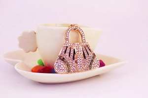 Detailed view of handbag keychain with crystal rhinestones and Greek fret pattern