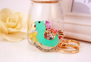 Detail of mint green rocking horse keychain with crystal rhinestones and gold lobster clasp