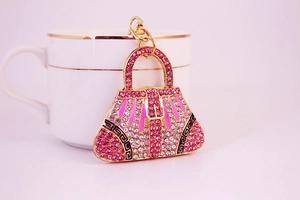 Detailed close-up of a pink rhinestone handbag keychain with golden alloy finish