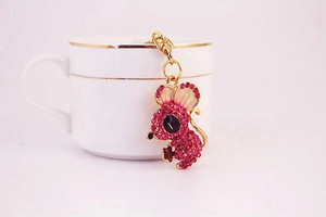 Close-up of pink crystal rhinestone mouse keychain with golden metal frame and lobster clasp