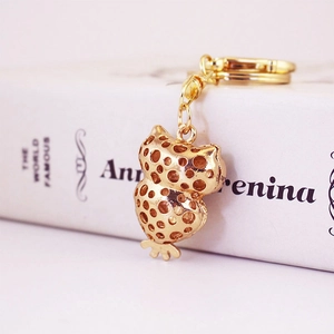 Creative owl keychain with gold hollow polka dot design and sturdy metal lobster clasp