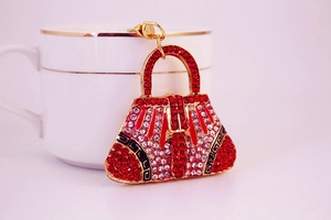 Detail of red rhinestone handbag keychain with gold metal frame and lobster clasp
