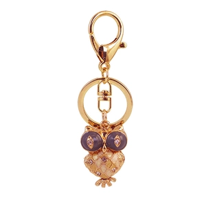Creative owl keychain with purple enamel eyes and sparkling crystals in gold metal