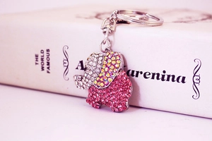 Close-up of pink and white crystal elephant keychain with polished silver metal clasp