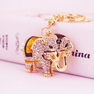 Exquisite gold elephant keychain with white rhinestones and black enamel accents for handbags