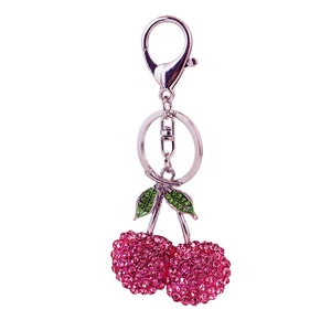 Sparkling pink rhinestone cherry keychain with green crystal leaves on silver keyring