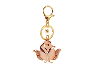 Detail of pink cat-eye stone rose keychain with gold metal plating and white rhinestones