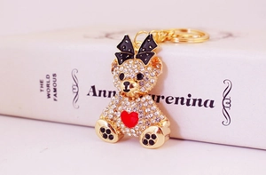 Close-up of rhinestone teddy bear keychain with red heart detail and gold lobster clasp