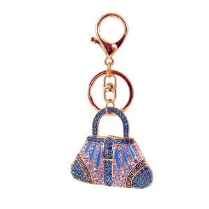 Sparkling crystal handbag keychain featuring pink and blue rhinestones on gold metal base