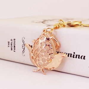 Cute golden teapot keychain with hollow polka dot design and opal stones for handbags