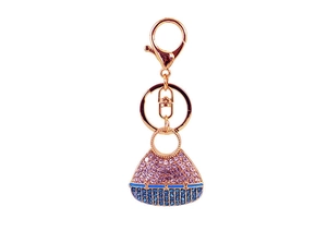 Detail shot of mini handbag keychain with rose gold plating and pink blue crystals
