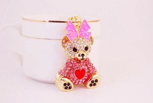 Close-up of sparkling rhinestone teddy bear keychain with pink crystals and heart charm