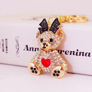 Sparkling rhinestone bear keychain with black polka dot bow and red heart detail