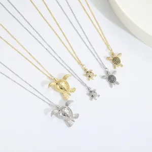 Three sizes of turtle necklaces in gold and silver with black and white zircon stones